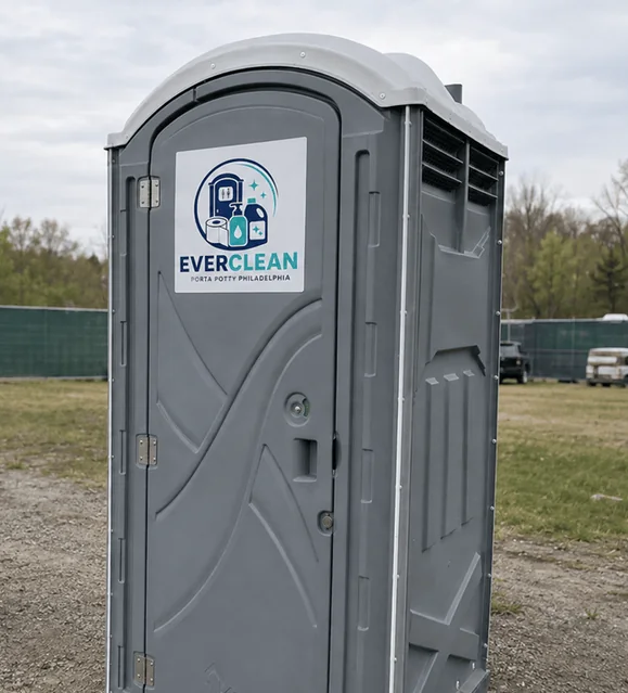 Grey deluxe porta potty unit with the Everclean Porta Potty Philadelphia logo on the door