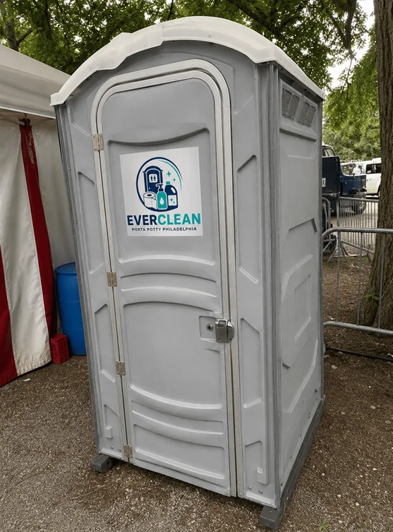 Grey Everclean Porta Potty Philadelphia unit positioned near an event marquee